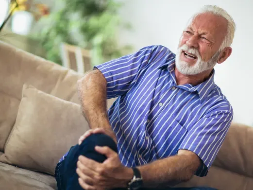 Patient experiencing chronic knee pain at home