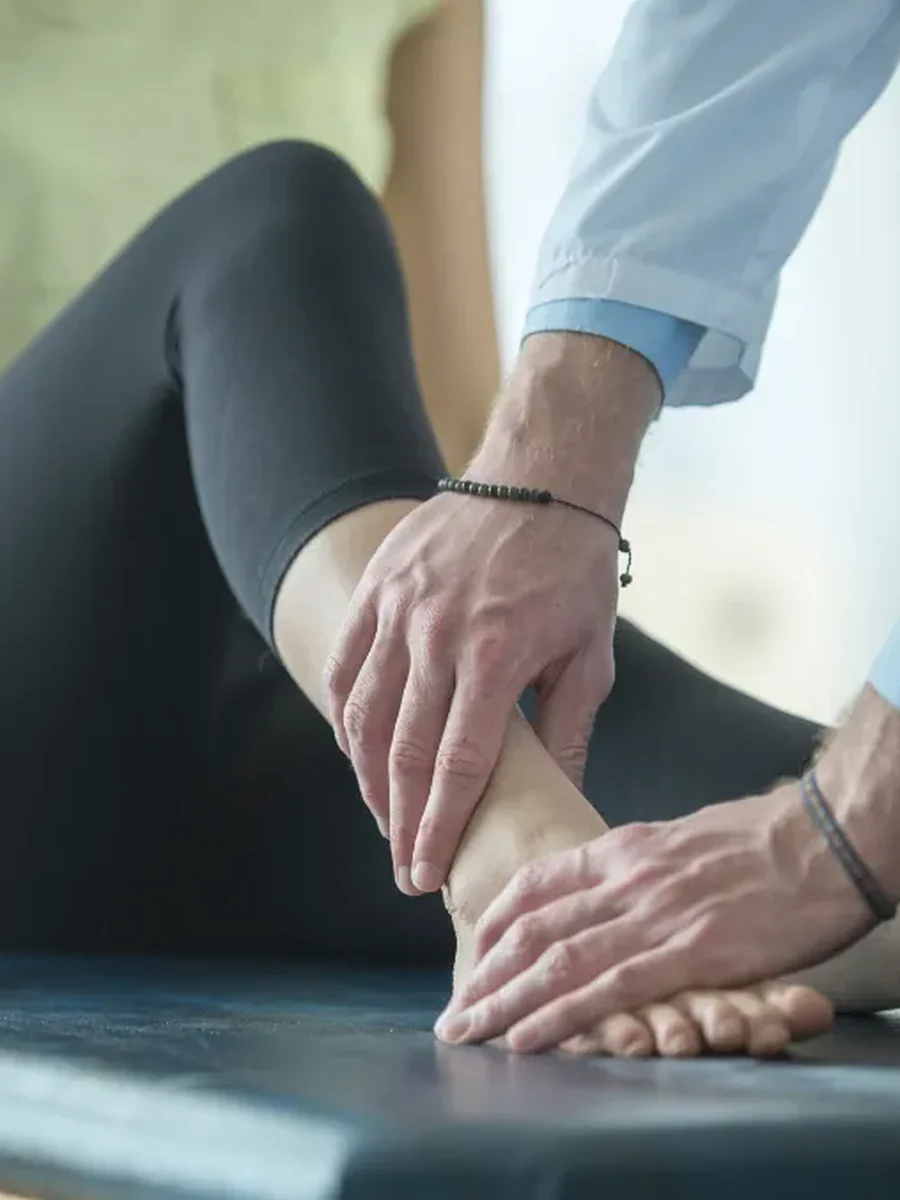A physical therapist listening to a patient describe their pain